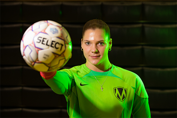 Motlow soccer player holds a soccer ball fith an outstretched arm